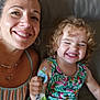 Joy participe au concours pour gagner de l'argent avec cette photo : woman, child, toddler, smiling, happy, couch, leather, curly_hair, striped_clothing, floral_dress, necklace, earrings, snack_pouch, indoor, portrait, family, casual, natural_light, joy, closeup