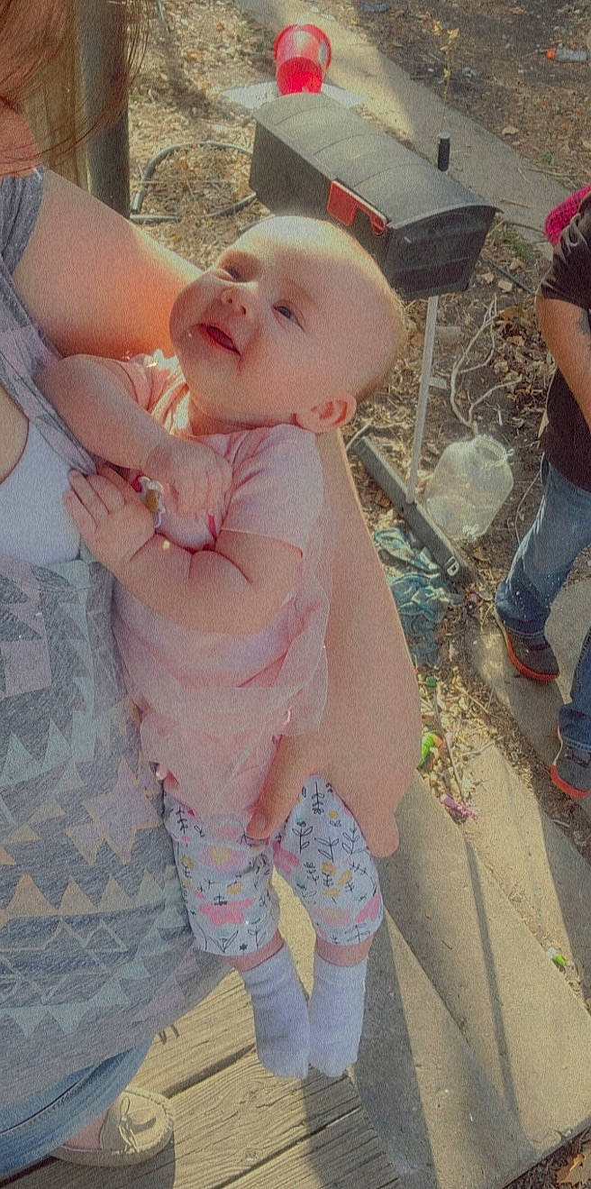 Kinsley is registered to the contest to win money with this photo: baby, baby_toddler_clothing, cheek, eye, face, finger, gesture, hairstyle, happy, head, human, interaction, lip, mouth, person, pink, skin, sleeve, thigh, thumb