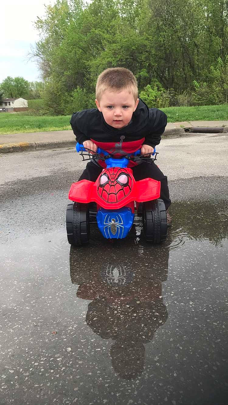 Kolten joined the competition — help win amazing prizes! asphalt, automotive_design, automotive_exterior, automotive_tire, electric_blue, fun, grass, leisure, motor_vehicle, motorsport, person, personal_protective_equipment, plant, riding_toy, road_surface, tire, toddler, tree, vehicle, water