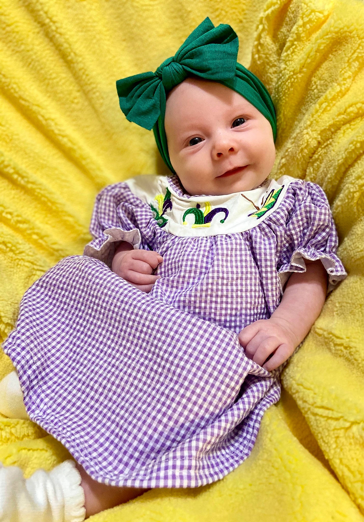 Jemma is registered to the contest to win money with this photo: baby, baby_toddler_clothing, cap, child, comfort, grass, happy, hat, headwear, linens, pattern, person, pink, purple, skin, sleeve, smile, sun_hat, textile, toddler