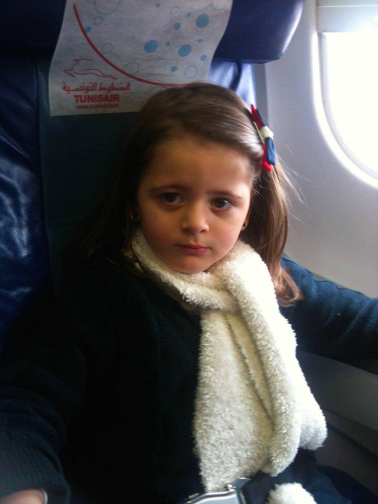 Mila a rejoint le concours — aidez-le/la à gagner de superbes lots ! air_travel, airline, blond, brown_hair, car_seat, cheek, child, chin, comfort, eyebrow, fun, fur, iris, lip, long_hair, nose, person, sitting, skin, toddler