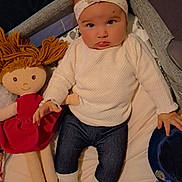 Ambre participe au concours pour gagner de l'argent avec cette photo : baby, infant, doll, headband, socks, jeans, white_sweater, bassinet, bed, toy, pacifier, pacifier_clip, plush_toy, hand, face, portrait, cute, indoor, lying_down, soft_toys