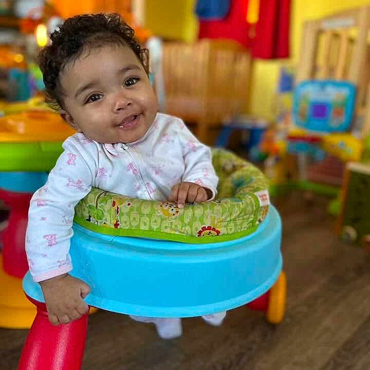 Velouria joined the competition — help win amazing prizes! baby, child, clothing, colorful, curly_hair, cute, floor, furniture, hand, happy, indoor, infant, person, playroom, portrait, seat, smiling, toys, walker, young