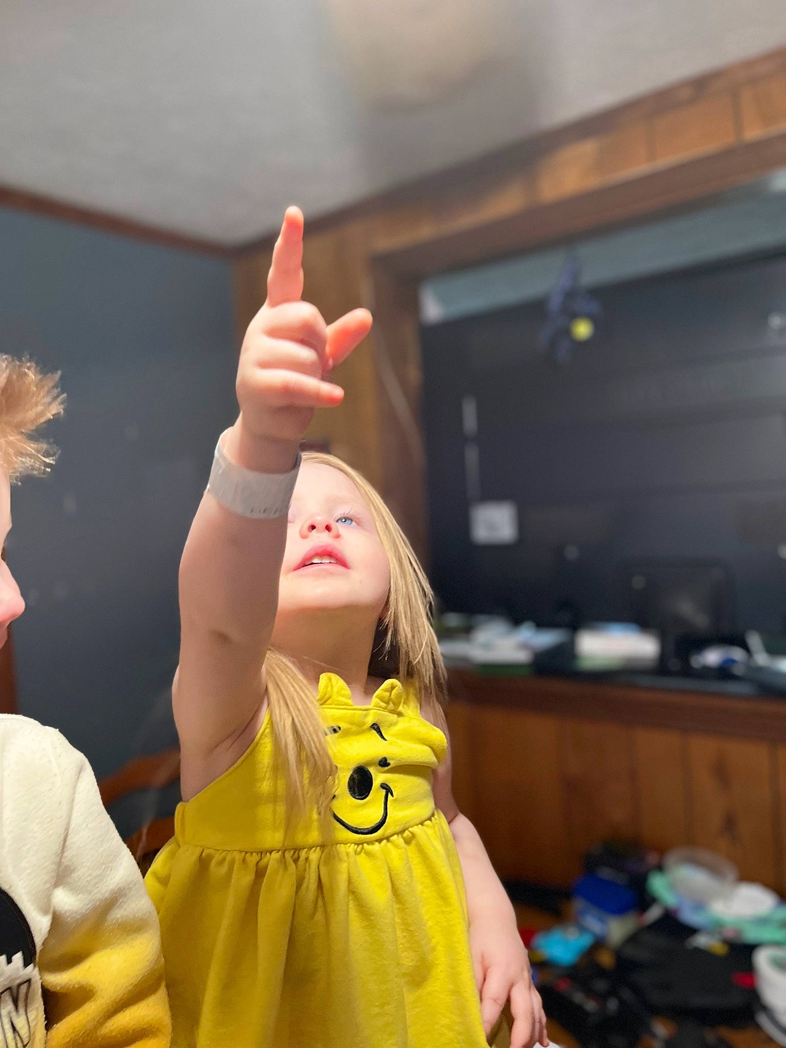 Ivory is registered to the contest to win money with this photo: backpack, child, costume, entertainment, event, fashion_design, finger, fun, gesture, glove, happy, luggage_and_bags, performing_arts, person, room, sign_language, smile, snapshot, television, thumb