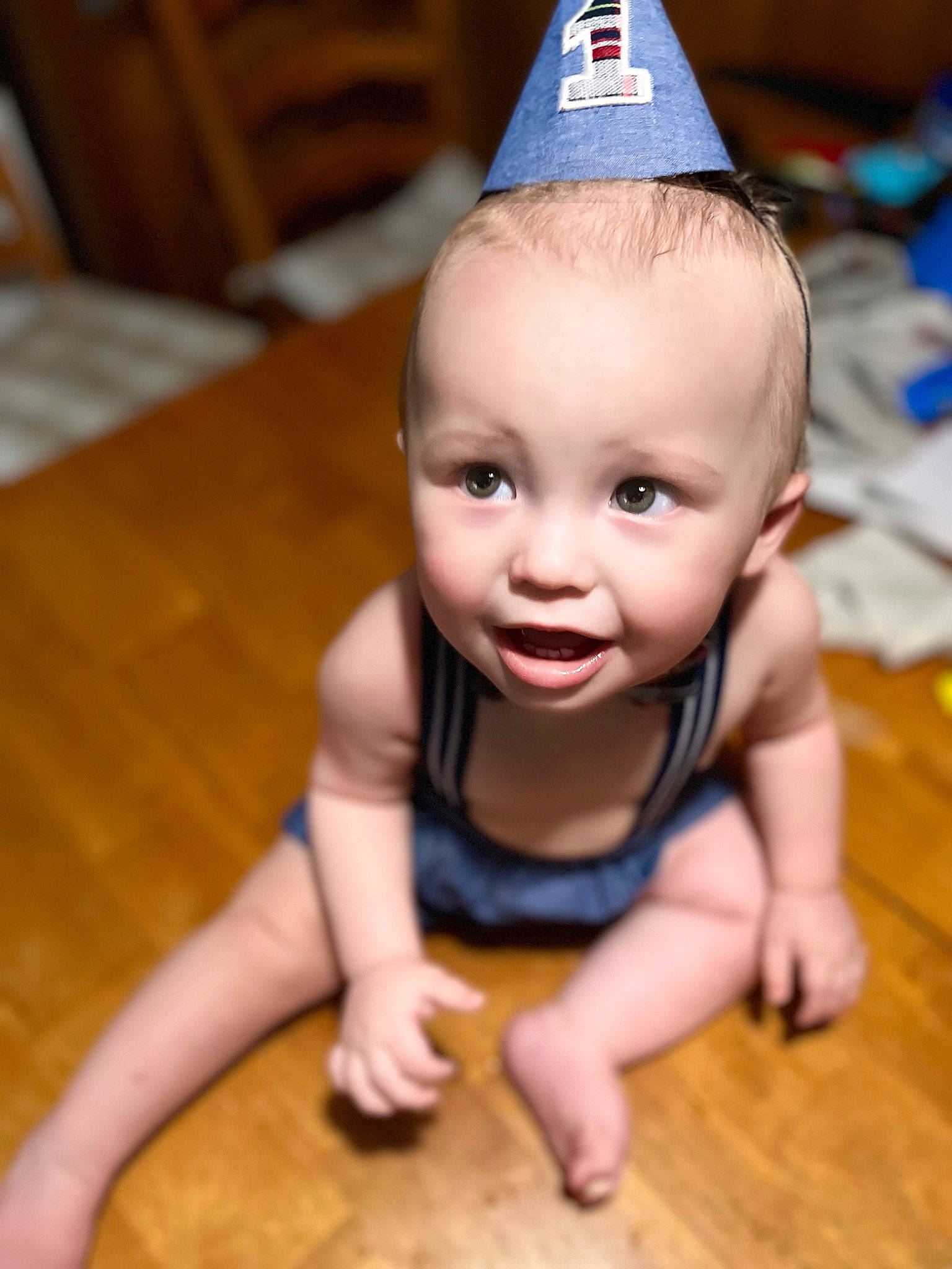 Walter is registered to the contest to win money with this photo: baby_toddler_clothing, cap, cheek, chin, cone, costume_hat, crawling, eye, finger, floor, flooring, happy, hardwood, mouth, nose, party_hat, person, skin, smile, toddler