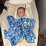 baby, sleeping, blanket, blue_blanket, baby_rocker, pacifier, indoor, cozy, resting, infant, soft_furniture, child, peaceful, clothing, head, face, comfort, relaxation, home, toddler