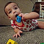 Hudson is registered to the contest to win money with this photo: toddler, child, indoor, carpet, toy, block, geometric_shape, playing, curious, person, furniture, living_room, colorful, hand, face, expression, couch, lamp, chair, baby