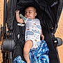 baby, sleeping, stroller, onesie, blanket, outdoor, infant, child, cute, peaceful, black_stroller, fabric, textile, animal_print, footwear, leg, hand, resting, portrait, baby_clothing