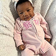 Mellody joined the competition — help win amazing prizes! baby, infant, child, headband, bow, blanket, onesie, pink_outfit, smile, cozy, fleece_blanket, portrait, lying_down, hand, feet, eyes, hair, baby_skin, floral_pattern, zipper