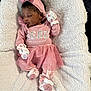 baby, infant, newborn, sleeping, pink_outfit, bow_headband, mittens, socks, tutu, glitter_text, fluffy_blanket, cozy, portrait, closeup, indoors, peaceful, soft_texture, sleepwear, child, cute