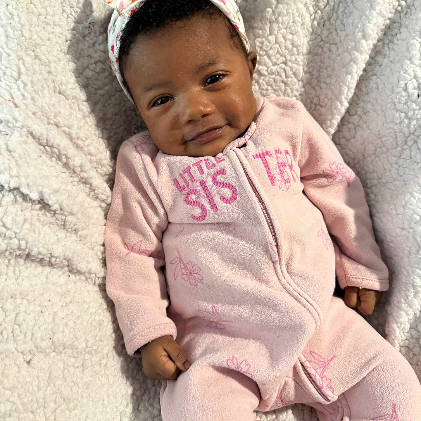 Mellody joined the competition — help win amazing prizes! baby, baby_skin, blanket, bow, child, cozy, eyes, feet, fleece_blanket, floral_pattern, hair, hand, headband, infant, lying_down, onesie, pink_outfit, portrait, smile, zipper