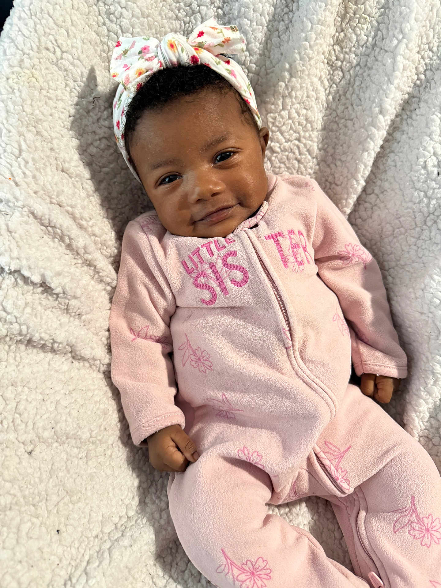 Mellody joined the competition — help win amazing prizes! baby, infant, child, headband, bow, blanket, onesie, pink_outfit, smile, cozy, fleece_blanket, portrait, lying_down, hand, feet, eyes, hair, baby_skin, floral_pattern, zipper