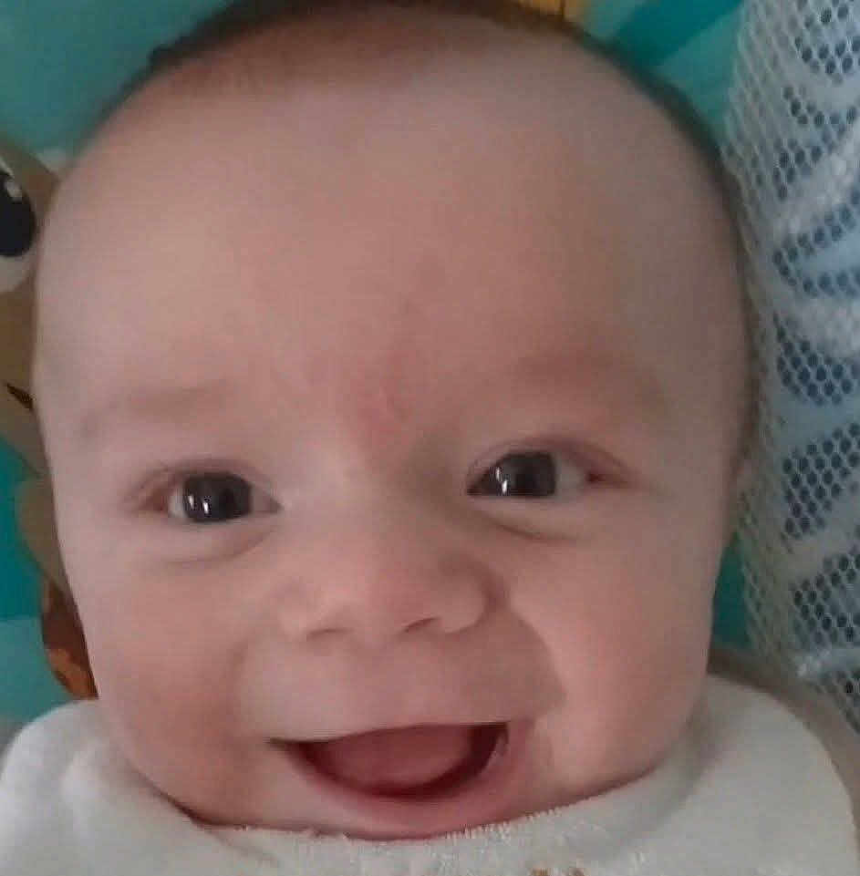 Micha is registered to the contest to win money with this photo: baby, smile, face, close_up, joyful, infant, eyes, happy, child, cute, skin, mouth, expression, person, head, cheeks, indoors, young, portrait, baby_clothing