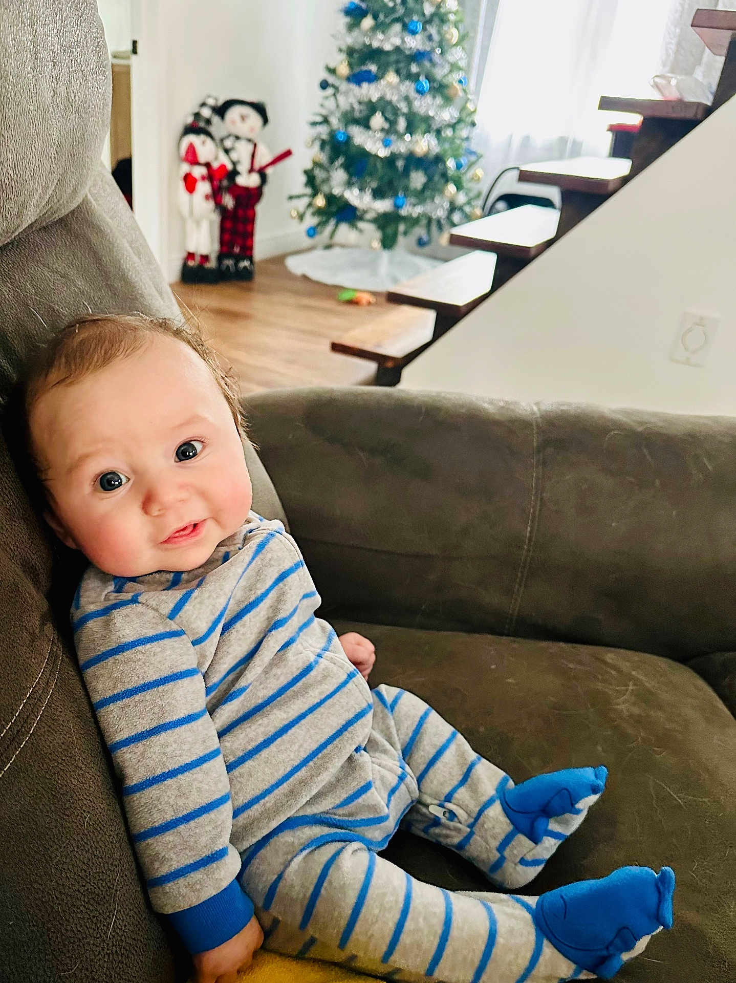 Colt joined the competition — help win amazing prizes! baby, child, pajamas, striped_clothing, couch, sofa, happy, smiling, face, indoors, christmas_tree, holiday_decorations, wood_floor, stairs, plush, cozy, infant, home, festive, blue