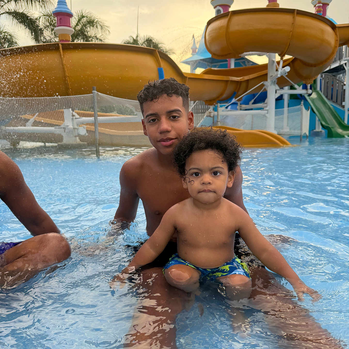 Millier is registered to the contest to win money with this photo: boys, child, colorful, curly_hair, family, fun, happy, leisure, outdoor, playful, pool, recreation, sitting, summer, sunset, swimming, vacation, water, water_park, water_slide