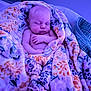 Kayson is registered to the contest to win money with this photo: baby, newborn, sleeping, blanket, floral, infant, wrapped, cozy, purple_light, peaceful, cute, soft, indoor, child, toddler, resting, comfort, person, portrait, warm