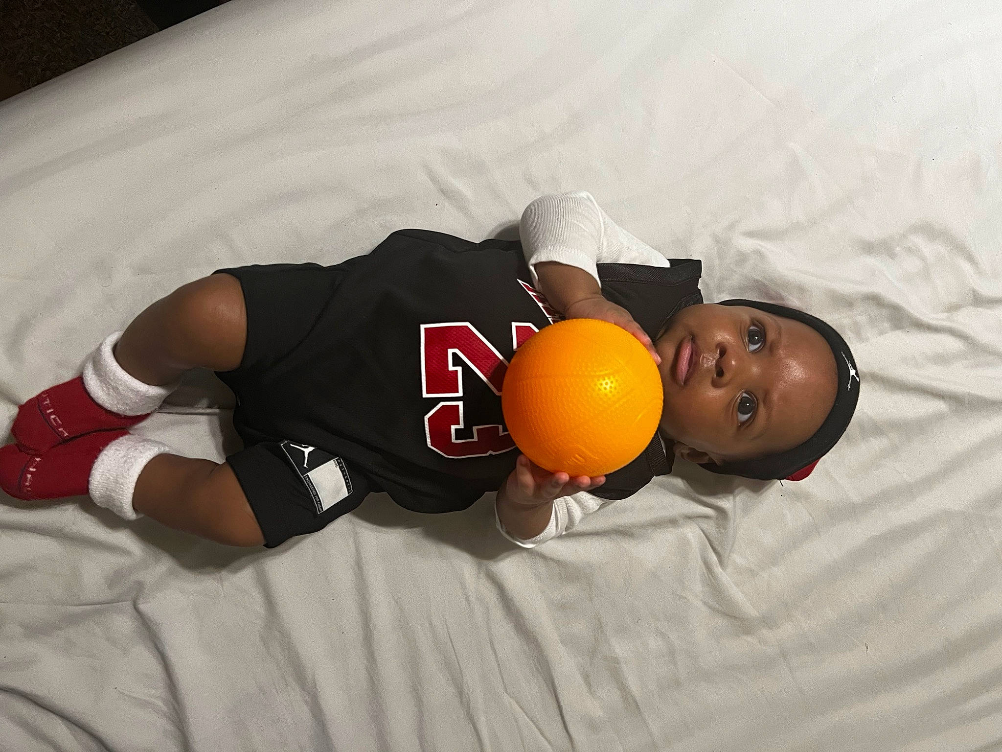 Zayvion is registered to the contest to win money with this photo: abdomen, ball, chest, child, citrus, comfort, elbow, flash_photography, flooring, food, fruit, fun, knee, mandarin_orange, orange, person, sportswear, t_shirt, tangerine, thigh