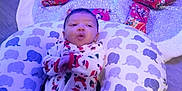 Carmello joined the competition — help win amazing prizes! baby, blue_lights, christmas_tree, cozy, cute, decoration, elephant_pattern, festive, floor, holiday, indoor, infant, ornaments, pajamas, pillow, relaxing, smiling, sparkly, tree_skirt, wrapped_presents