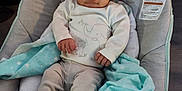 Carmello is registered to the contest to win money with this photo: baby, infant, child, bouncer, blanket, hat, clothing, face, legs, feet, socks, elephant_print, striped_pants, soft_toys, comfort, indoor, seated, cute, resting, young