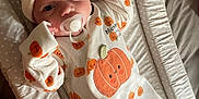 Kody is registered to the contest to win money with this photo: adorable, baby, baby_clothes, changing_pad, child, cozy, cute, hat, indoors, infant, lying_down, newborn, onesie, pacifier, person, polka_dots, portrait, pumpkin_pattern, sleepwear, soft_fabric