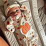 adorable, baby, baby_clothes, changing_pad, child, cozy, cute, hat, indoors, infant, lying_down, newborn, onesie, pacifier, person, polka_dots, portrait, pumpkin_pattern, sleepwear, soft_fabric