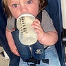 Kody joined the competition — help win amazing prizes! toddler, child, bottle, drinking, stroller, denim_shorts, grey_shirt, hair, face, eyes, hand, seatbelt, baby, casual_clothing, indoor, curious, skin, legs, footwear, baby_care