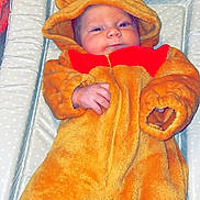 Kody joined the competition — help win amazing prizes! baby, bear, blanket, changing_pad, child, costume, cute, fabric, face, hand, hood, indoor, infant, lying_down, onesie, orange, person, polka_dot, smile, soft