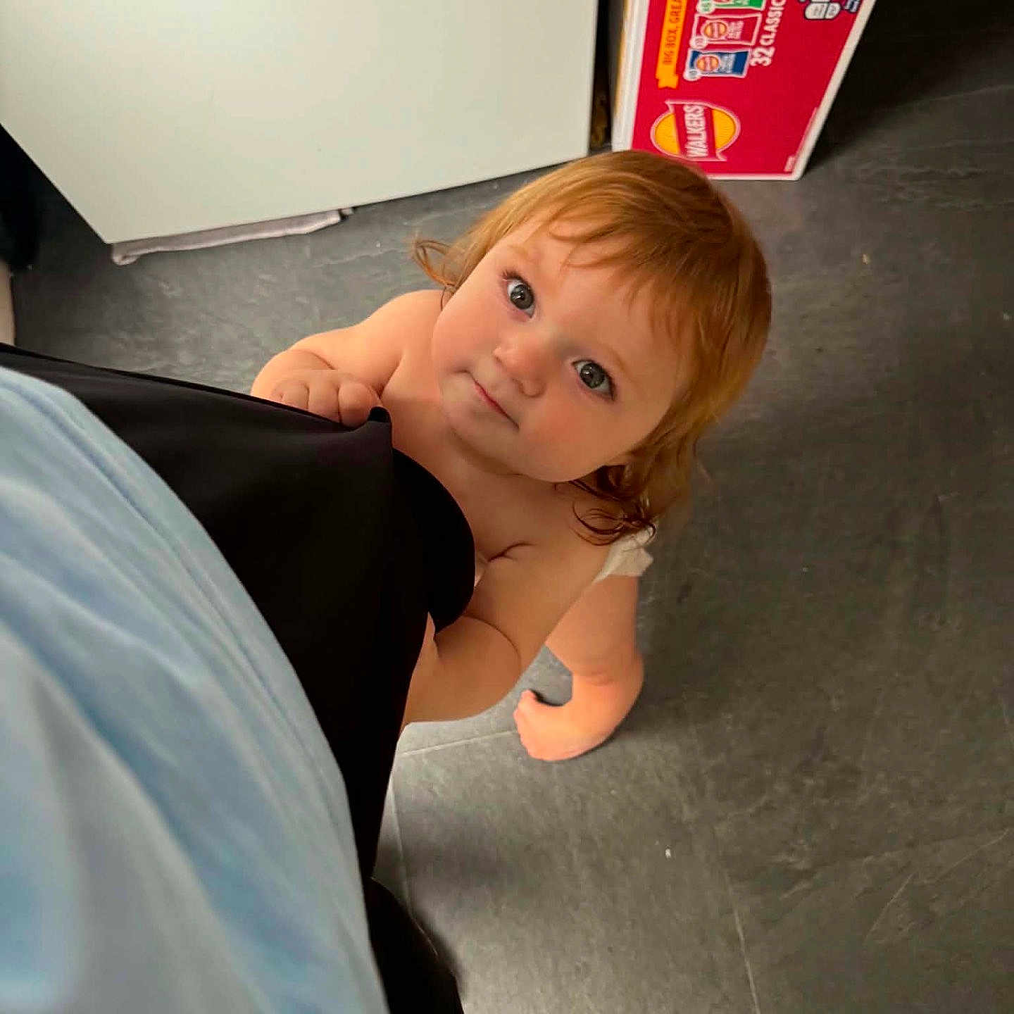 Kody joined the competition — help win amazing prizes! toddler, child, barefoot, curious, kitchen, floor, snack_box, looking_up, clothing, person, indoor, young_child, hair, face, hand, diaper, flooring, orange_bag, light, expression