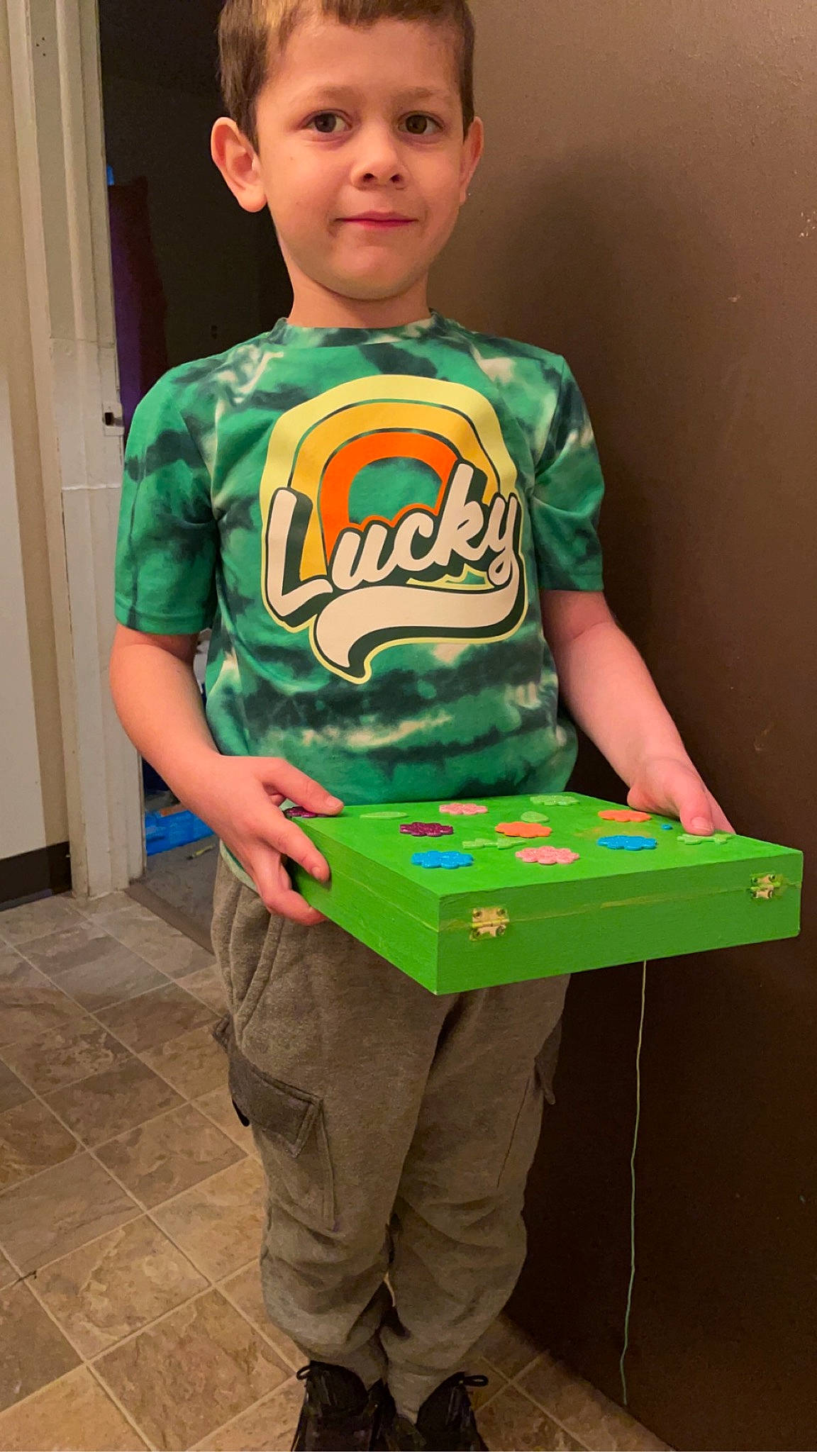 Bentley is registered to the contest to win money with this photo: box, cap, chair, child, door, electronic_instrument, eyewear, fun, gadget, gamer, happy, indoor_games_and_sports, joy, person, personal_protective_equipment, recreation, recreation_room, sleeve, t_shirt, table