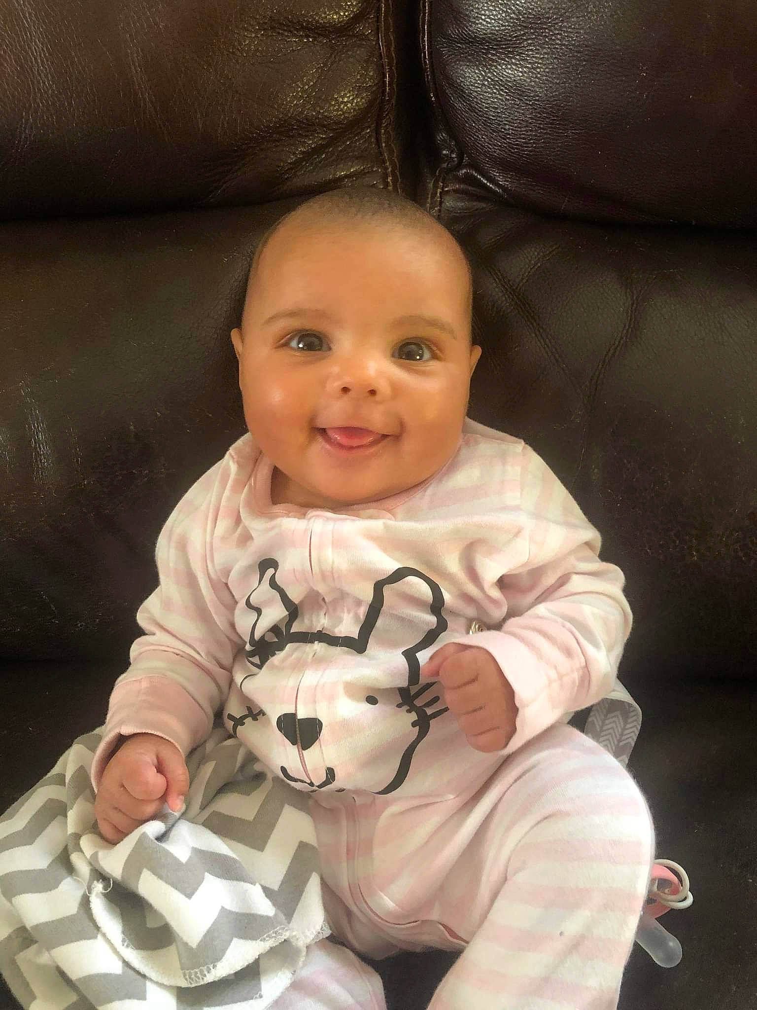 Venus is registered to the contest to win money with this photo: baby, baby_products, baby_toddler_clothing, carmine, cheek, child, comfort, couch, eye, fun, happy, head, joy, person, sitting, skin, sleeve, smile, t_shirt, thumb