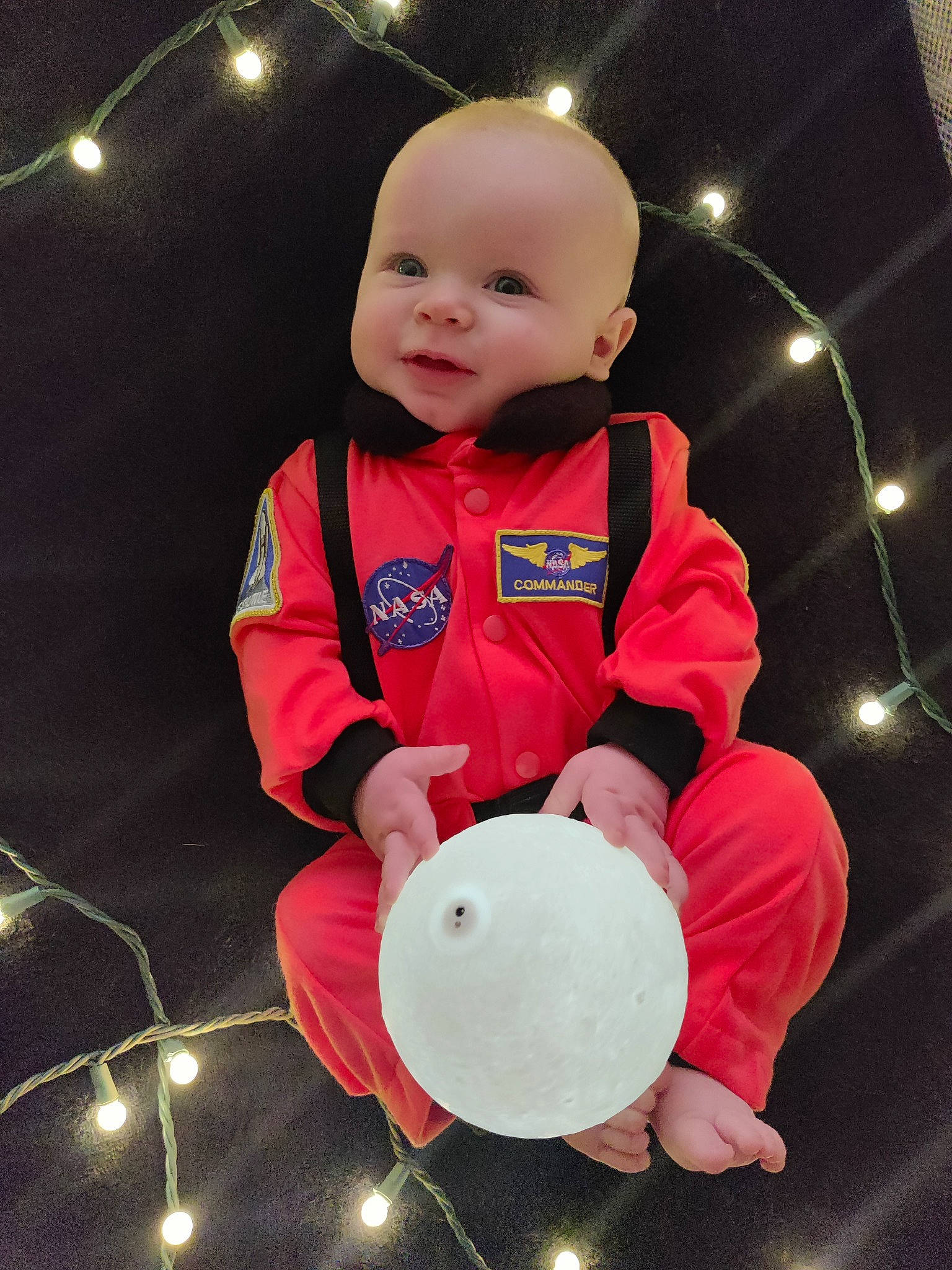Keith is registered to the contest to win money with this photo: arm, baby, baby_toddler_clothing, carmine, cheek, child, circle, costume, fun, happy, hat, person, personal_protective_equipment, sitting, sleeve, smile, space, t_shirt, toddler, uniform