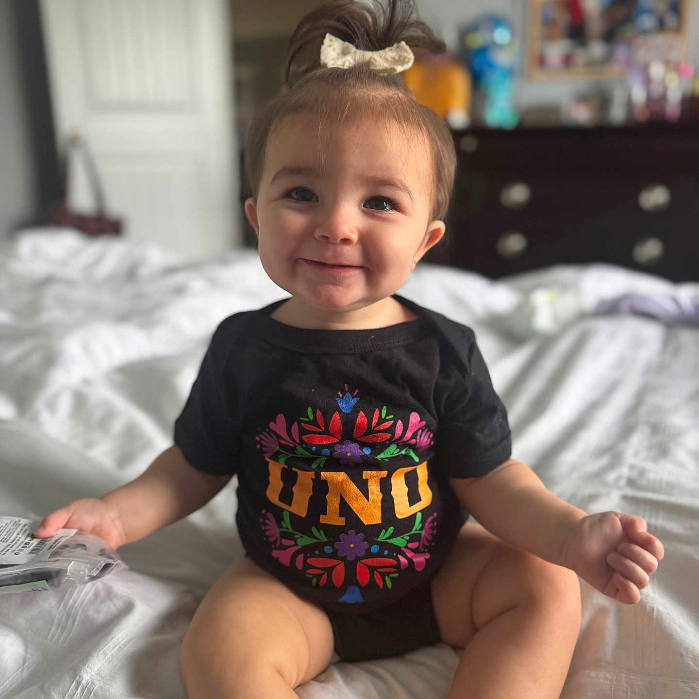 Gabriella joined the competition — help win amazing prizes! baby, bed, bedroom, bodypart, clothing, face, finger, furniture, hand, happy, head, indoors, person, photography, portrait, room, shorts, sitting, smile, t_shirt