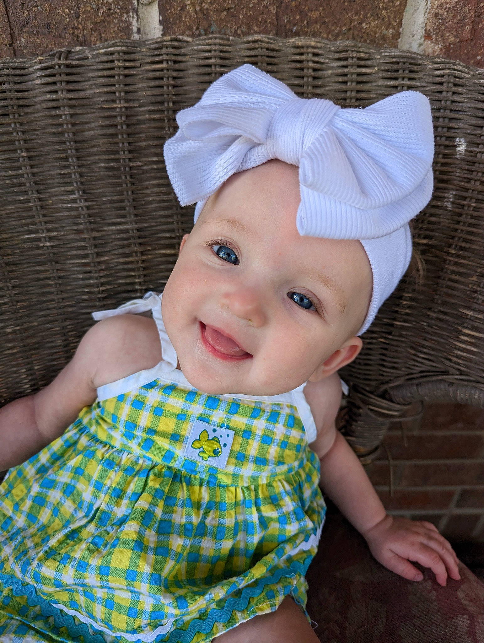 Echo is registered to the contest to win money with this photo: baby, baby_toddler_clothing, beauty, cap, child, costume_hat, fashion_accessory, grass, happy, hat, headgear, headwear, joy, pattern, person, pink, plaid, skin, sleeve, smile