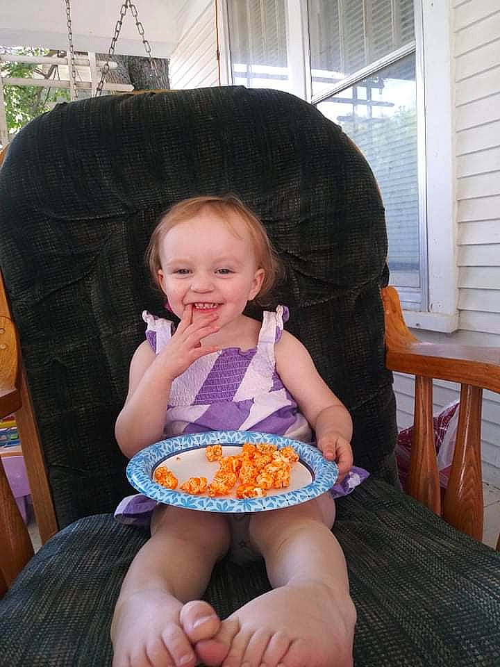 Sadie is registered to the contest to win money with this photo: baby, chair, child, cuisine, eating, face, finger, food, food_craving, fun, happy, joy, person, sharing, sitting, smile, sweet_corn, tableware, thumb, toddler