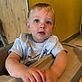 Carter joined the competition — help win amazing prizes! baby, blue_eyes, casual_clothing, child, curious_expression, face, furniture, hands, high_chair, indoor, light_skin, person, portrait, short_hair, short_sleeve_shirt, table, toddler, wood_panel, yellow_wall, young_child
