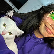 Ellie joined the competition — help win amazing prizes! casual, cat, closeup, cozy, cuddling, cute, furry, glasses, green_eyes, home, indoor, living_room, person, pet, portrait, purple_hoodie, relaxed, smile, television, white_cat