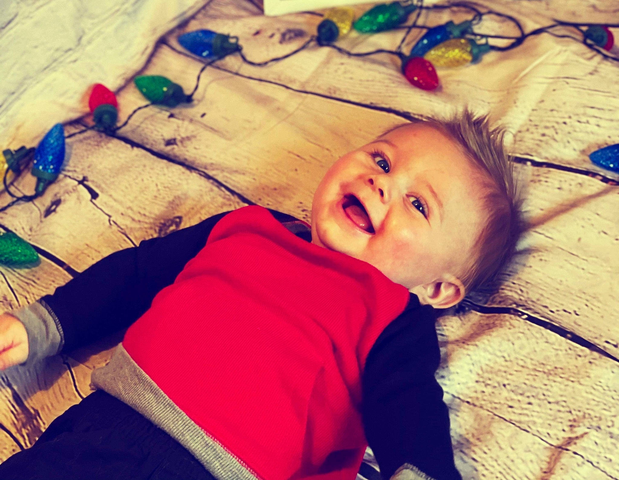 Drew is registered to the contest to win money with this photo: arthropod, baby, baby_toddler_clothing, cheek, child, foot, happy, human, insect, invertebrate, person, slipper, sock, toddler