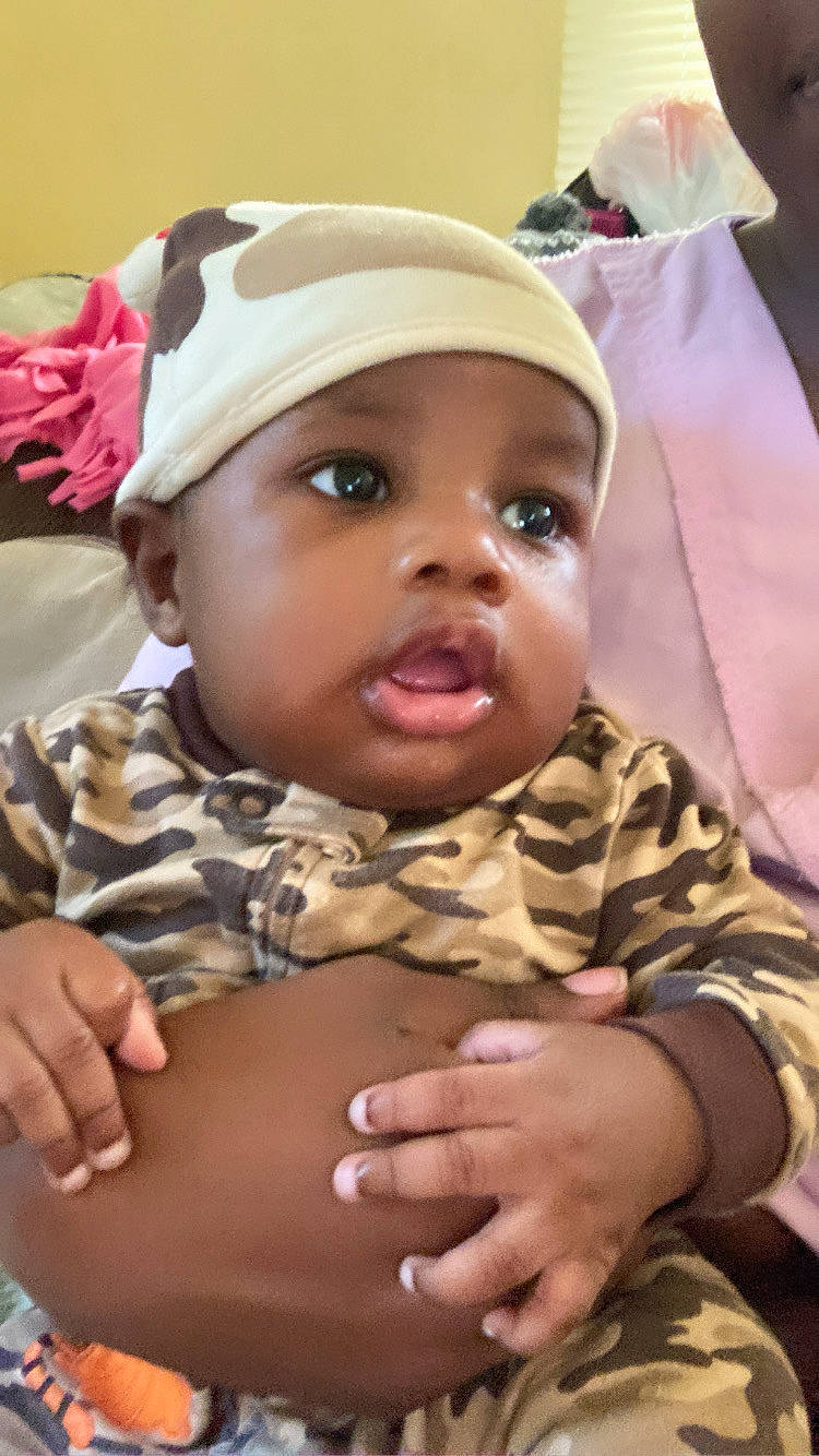 Jamichael is registered to the contest to win money with this photo: baby, baby_toddler_clothing, cheek, child, chin, comfort, eye, eyebrow, eyelash, facial_expression, gesture, hand, happy, headwear, lip, mouth, nose, person, skin, stomach