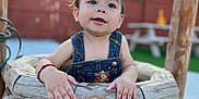 Basilio joined the competition — help win amazing prizes! child, baby, one_year_old, crown, denim_overalls, outdoor, wooden_well, grass, picnic_table, fence, happy, curious, toddler, daylight, portrait, smiling, playful, young_child, nature, casual_clothing