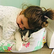 Greypants joined the competition — help win amazing prizes! child, cat, indoor, cushion, floor, wall, baseboard, hair_tie, white_clothing, gray_cat, floral_pattern, snuggling, resting, cute, pet, affection, tenderness, girl, cozy, closeup