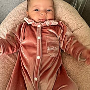 Annalya a rejoint le concours — aidez-le/la à gagner de superbes lots ! baby, infant, onesie, pink_clothing, velvet, pocket, cushion, face, eyes, bottle, soft_texture, neutral_background, cute, child, portrait, sleepwear, indoor, resting, comfortable, small