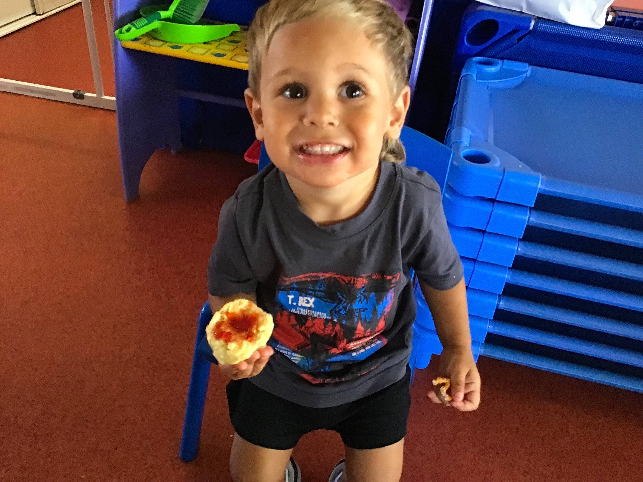 Tyler is registered to the contest to win money with this photo: automotive_exterior, bumper, child, electric_blue, family_car, food, fun, happy, joy, junk_food, leisure, motor_vehicle, person, play, recreation, smile, standing, t_shirt, toddler, trunk