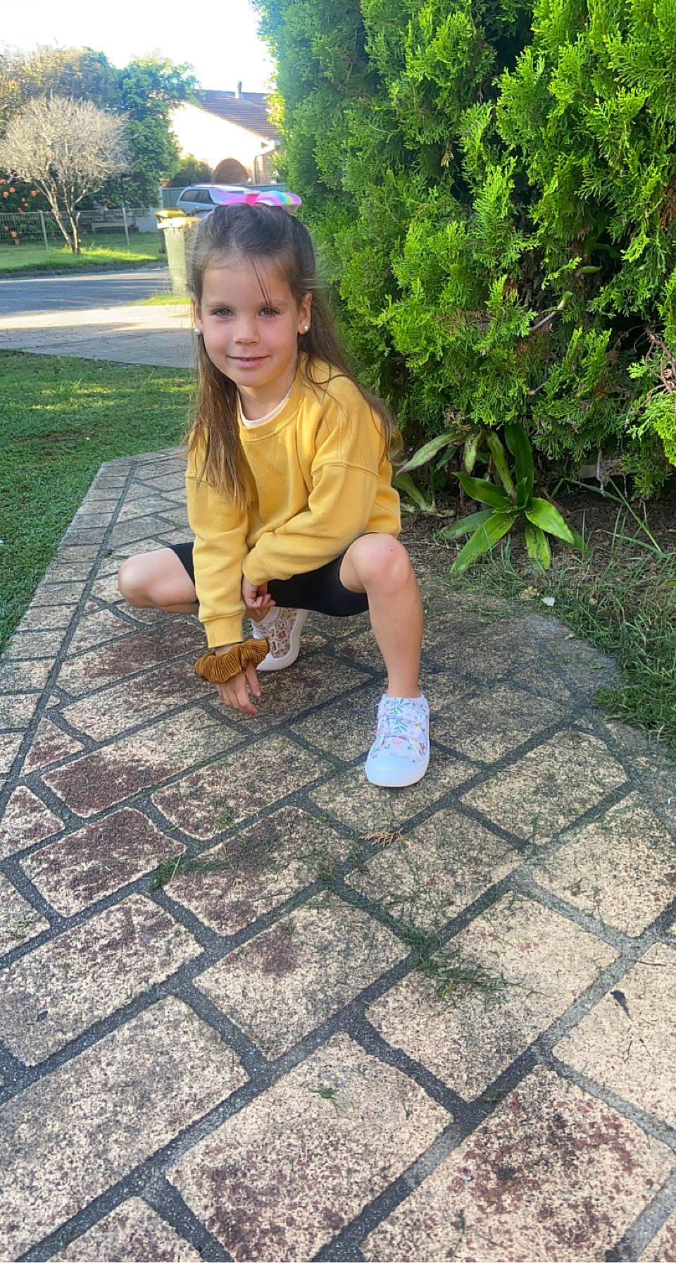 Bailee is registered to the contest to win money with this photo: child, flagstone, flooring, fun, garden, grass, human_leg, joy, leg, leisure, people_in_nature, person, plant, recreation, road_surface, sidewalk, sitting, smile, soil, terrestrial_plant