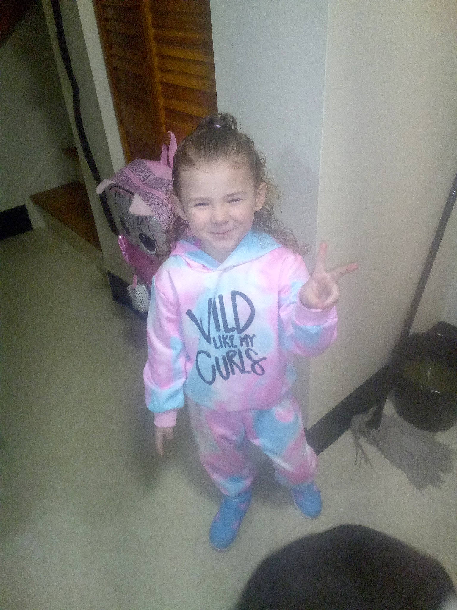 Blake is registered to the contest to win money with this photo: baby_toddler_clothing, chair, child, floor, flooring, fun, hardwood, joy, magenta, mammal, person, personal_protective_equipment, pink, purple, room, sleeve, smile, t_shirt, thumb, toddler