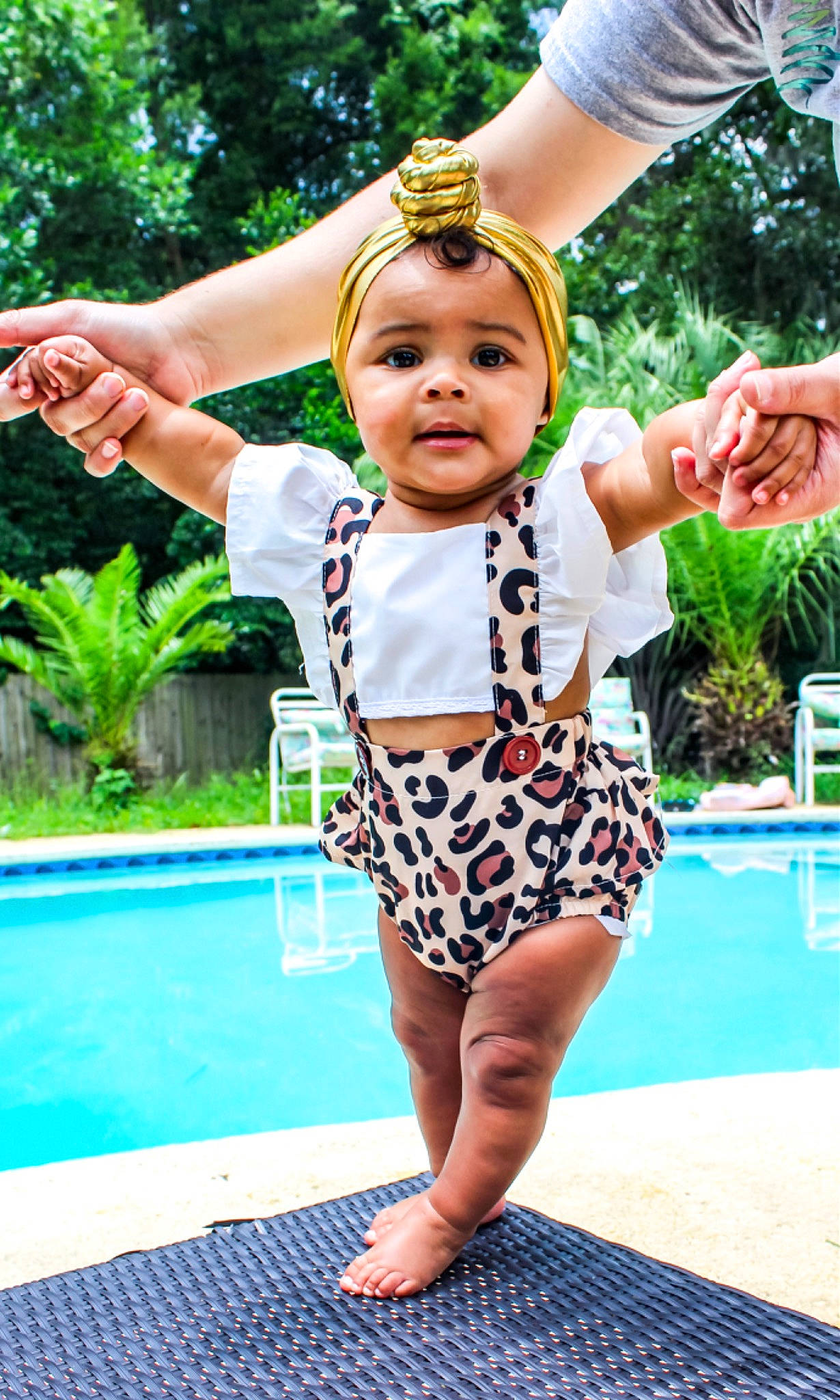 Jordynn joined the competition — help win amazing prizes! baby_toddler_clothing, barefoot, blue, electric_blue, event, fun, gesture, grass, green, hand, happy, headwear, leisure, person, plant, recreation, summer, swimming_pool, thigh, toddler
