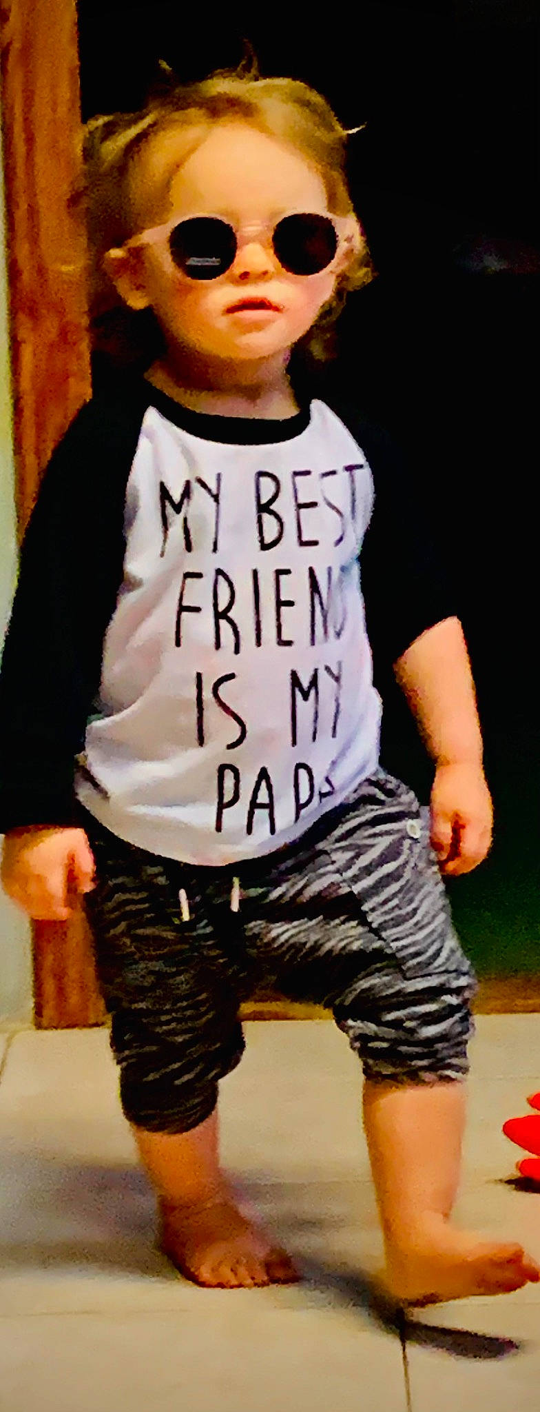 Ellie is registered to the contest to win money with this photo: belt, clothing, cool, denim, elbow, eyewear, fashion_design, hood, jersey, knee, neck, outerwear, pattern, person, personal_protective_equipment, sleeve, sportswear, t_shirt, thigh, top