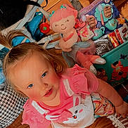 Journey joined the competition — help win amazing prizes! child, girl, blue_eyes, pink_clothing, high_ponytail, toy, stuffed_animal, wooden_floor, colorful, box, fairy_illustrations, smiling, indoor, playtime, casual_shoe, patterned_bag, happy, cute, young_child, floor