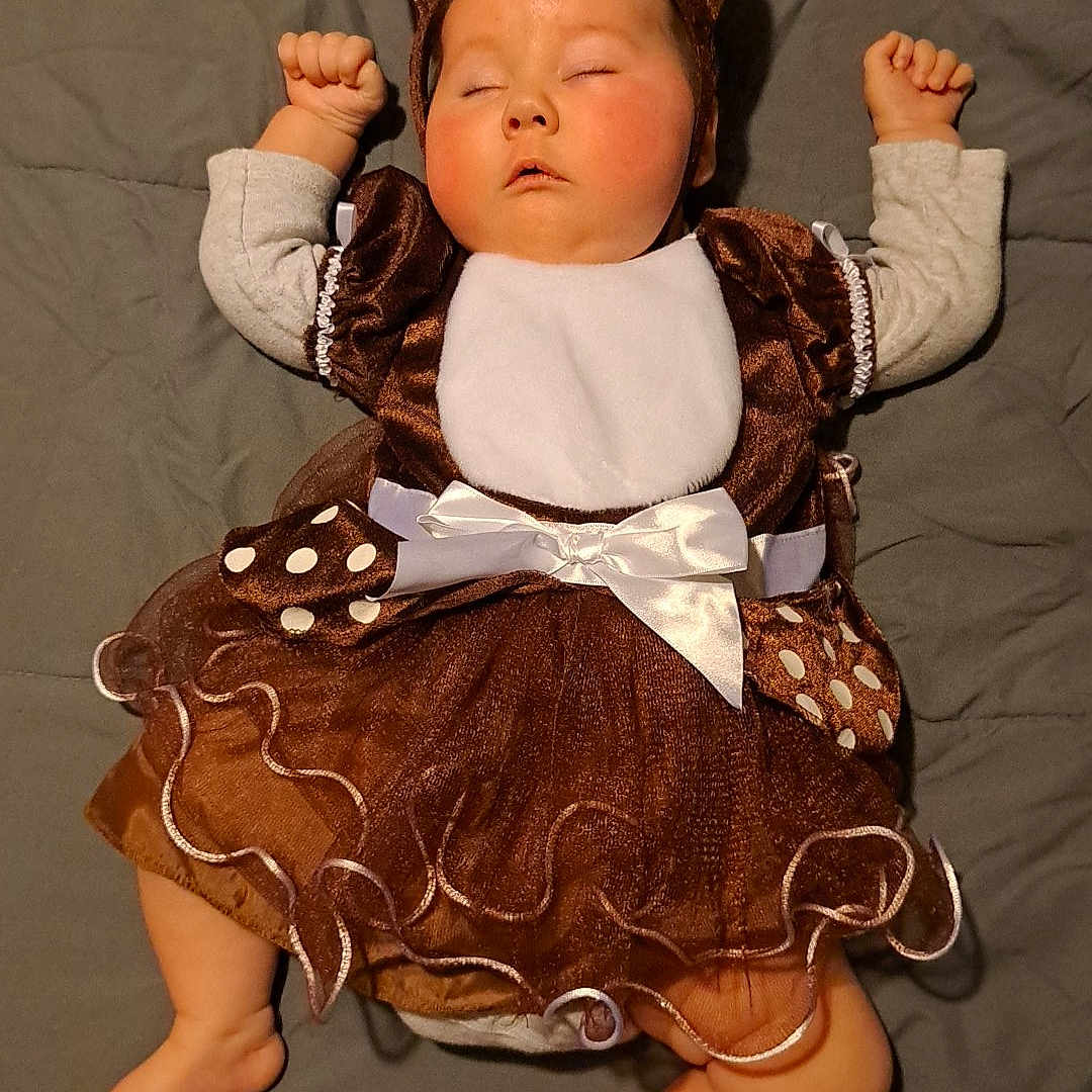 Elowyn is registered to the contest to win money with this photo: accessories, baby, bodypart, clothing, costume, couch, crown, dress, face, finger, furniture, hand, hat, head, jewelry, newborn, person, photography, portrait, sleeping