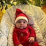Shiloh joined the competition — help win amazing prizes! baby, infant, christmas, holiday, red_clothing, santa_hat, seat, cushion, indoors, decorations, tree, lights, festive, cute, child, portrait, smiling, holiday_season, warm, cozy