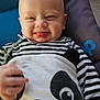 baby, blue_background, child, clothing, cushion, cute, face, hand, happy, head, indoor, infant, panda_design, person, portrait, purple_background, smiling, striped_clothing, tongue_out, young